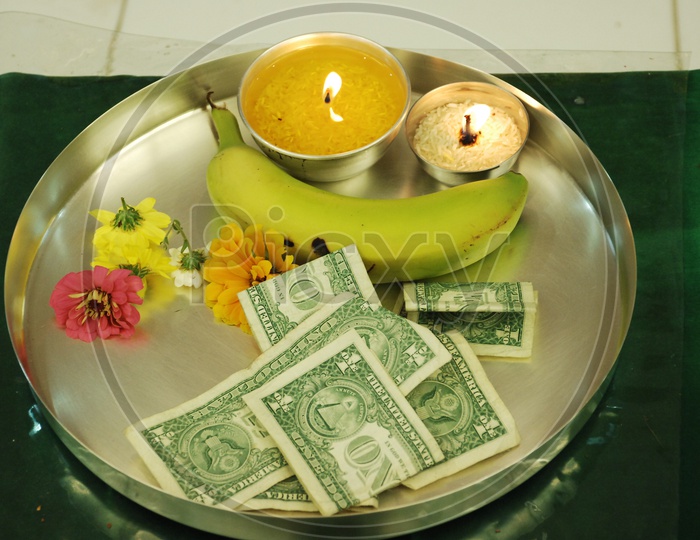 Dollar notes on a plate during worship