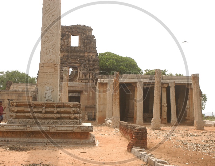 Ancient temple ruins alongside the stone pillars