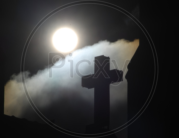 Silhouette of church cross during the sunlight
