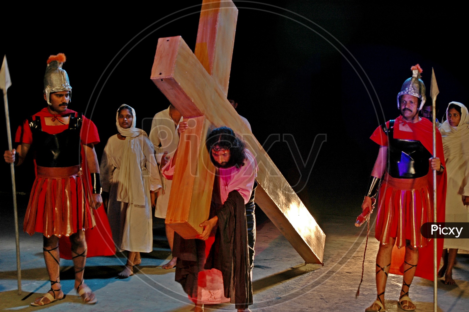Man dressed up as Jesus carrying cross during a skit