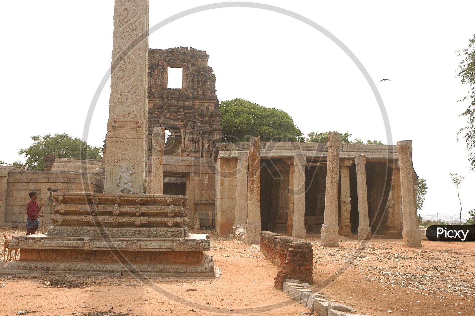 Ancient temple ruins alongside the stone pillars