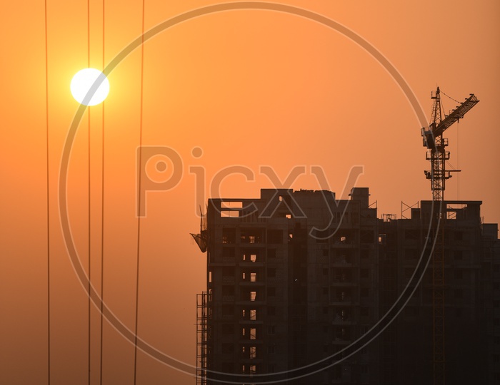 Sunset with High rise building in construction in foreground