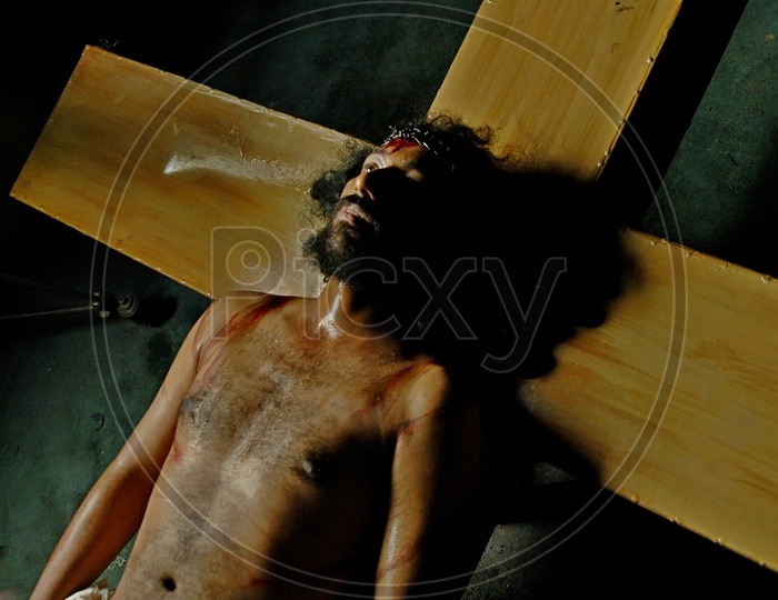 Man dressed up as Jesus crucification during a skit