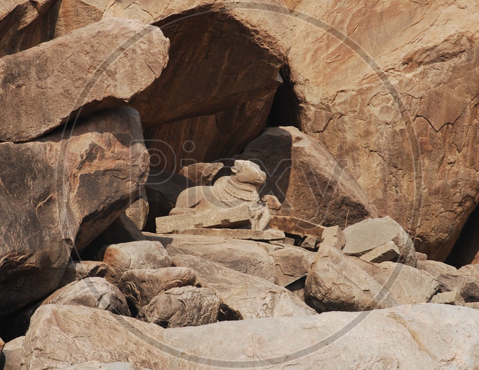 Hampi temple ruins - Nandi between the mountain rocks