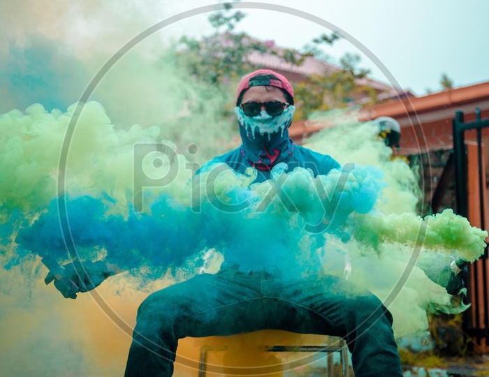 a seated person with smoke bomb
