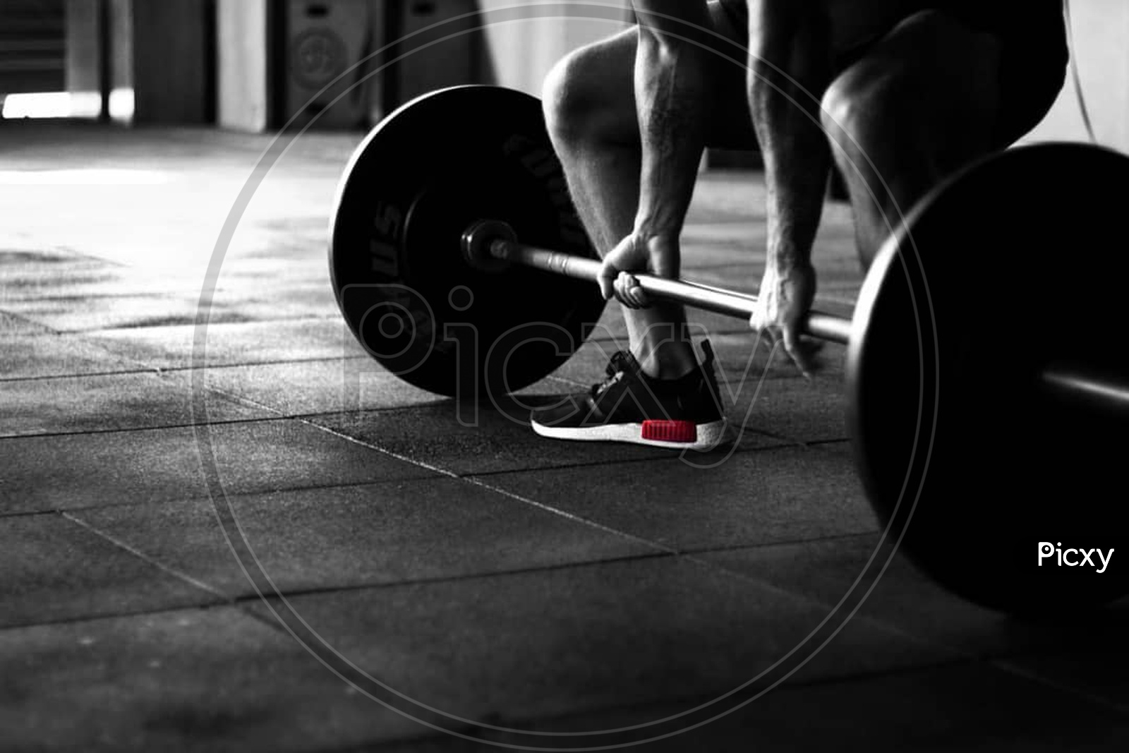 A person performing dead lift in a gym