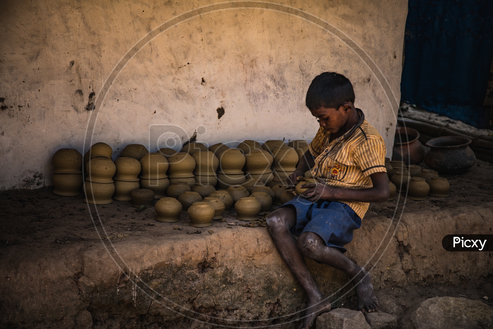 A Boy Carving The Clay Pots  in tribal Village