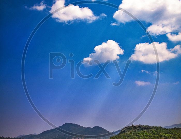 Cotton Clouds On Blue Sky Over Agricultural Fields