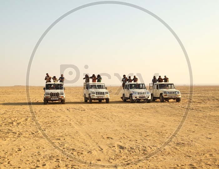 people moving in vehicles in the desert