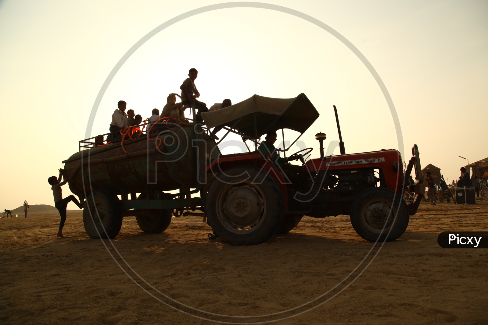 silhouette of the people moving in a tractor