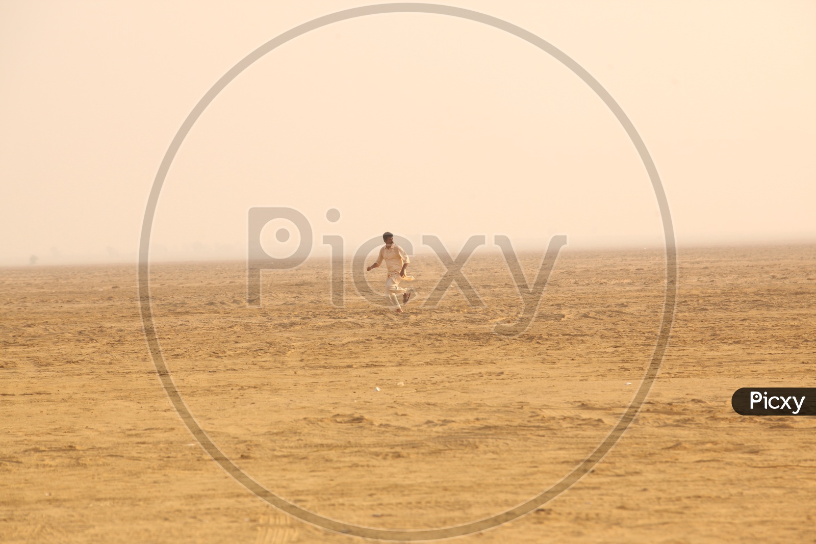 Indian man walking in a Desert