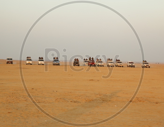 group of people on the vehicles in a desert