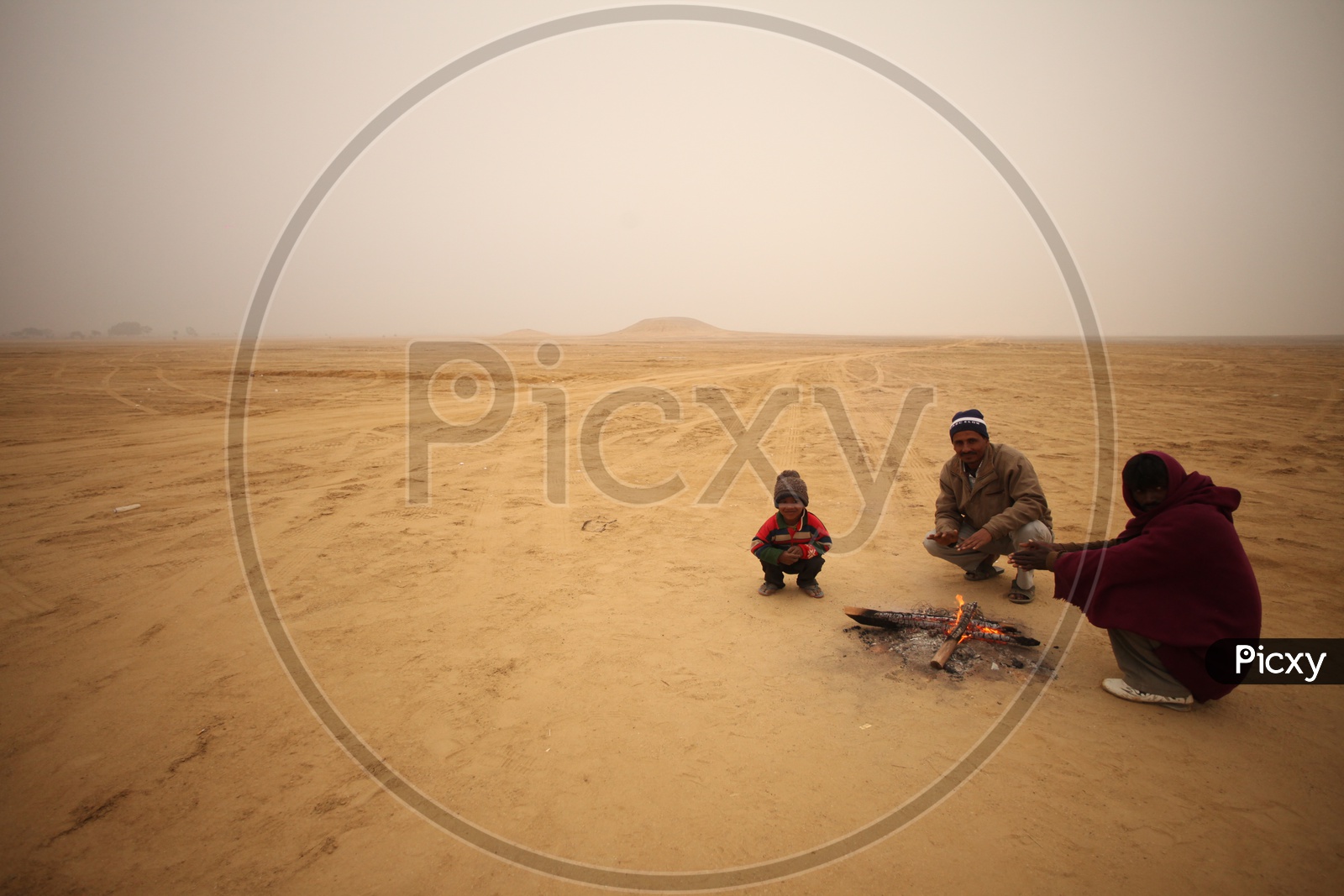 People in a Desert with small camp fire