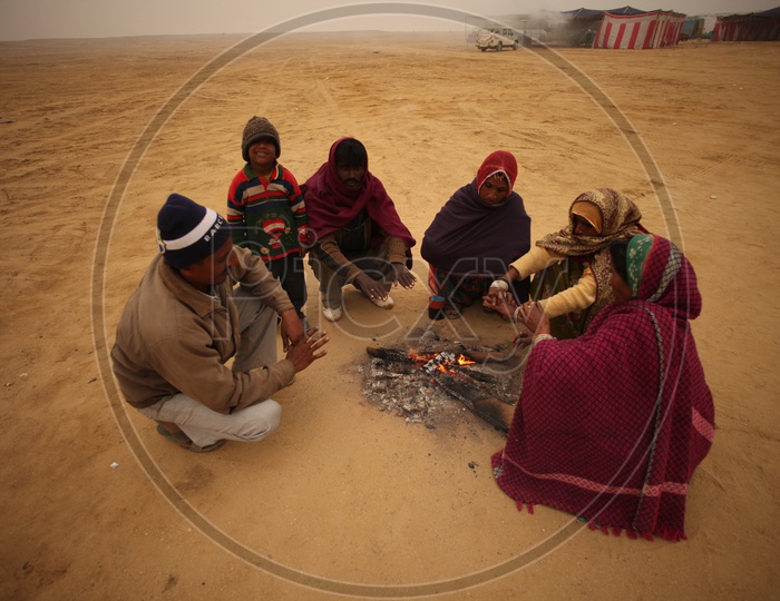 People in a desert with camp fire, Winter