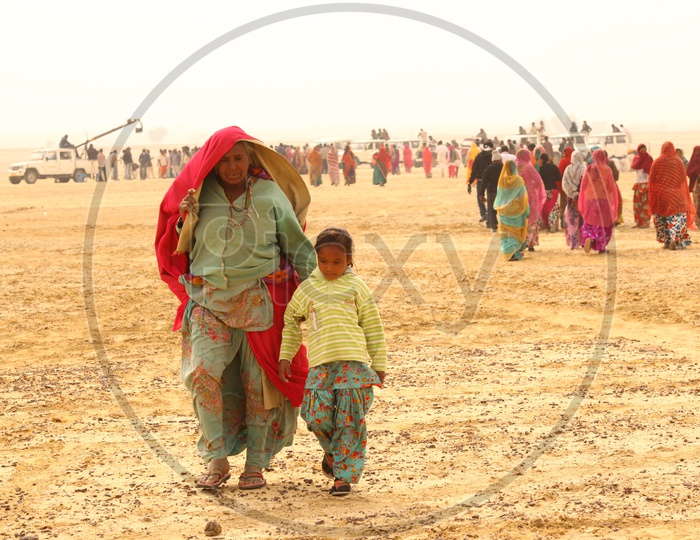 Indian woman walking in a desert