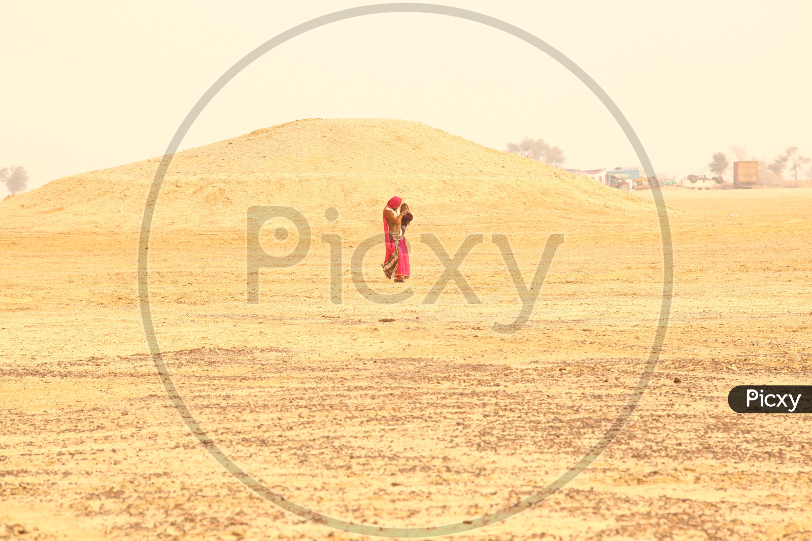 Indian woman walking in a desert