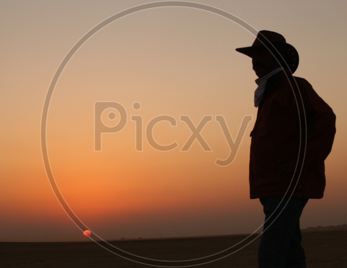 silhouette of a person with a cowboy hat
