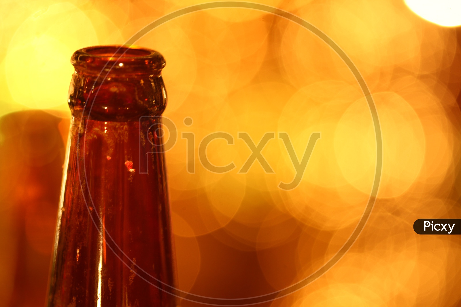 Close up of an empty glass bottle with bokeh background