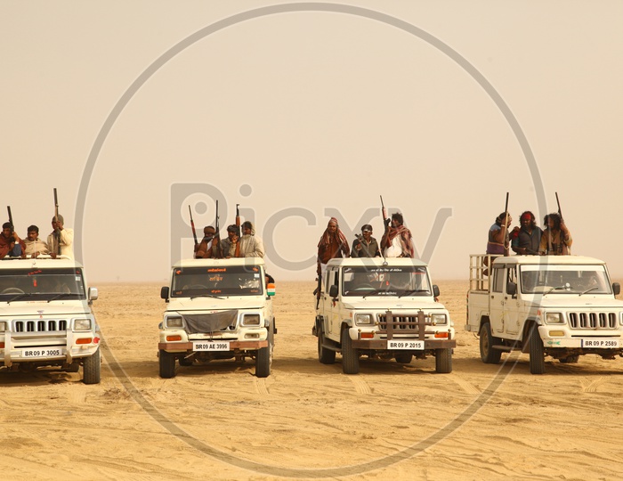 vehicles with bandits moving in desert