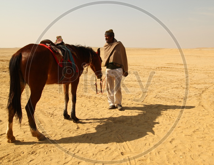 A man and a horse in the desert