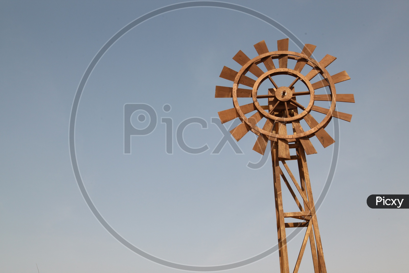 wooden wind mill in the desert