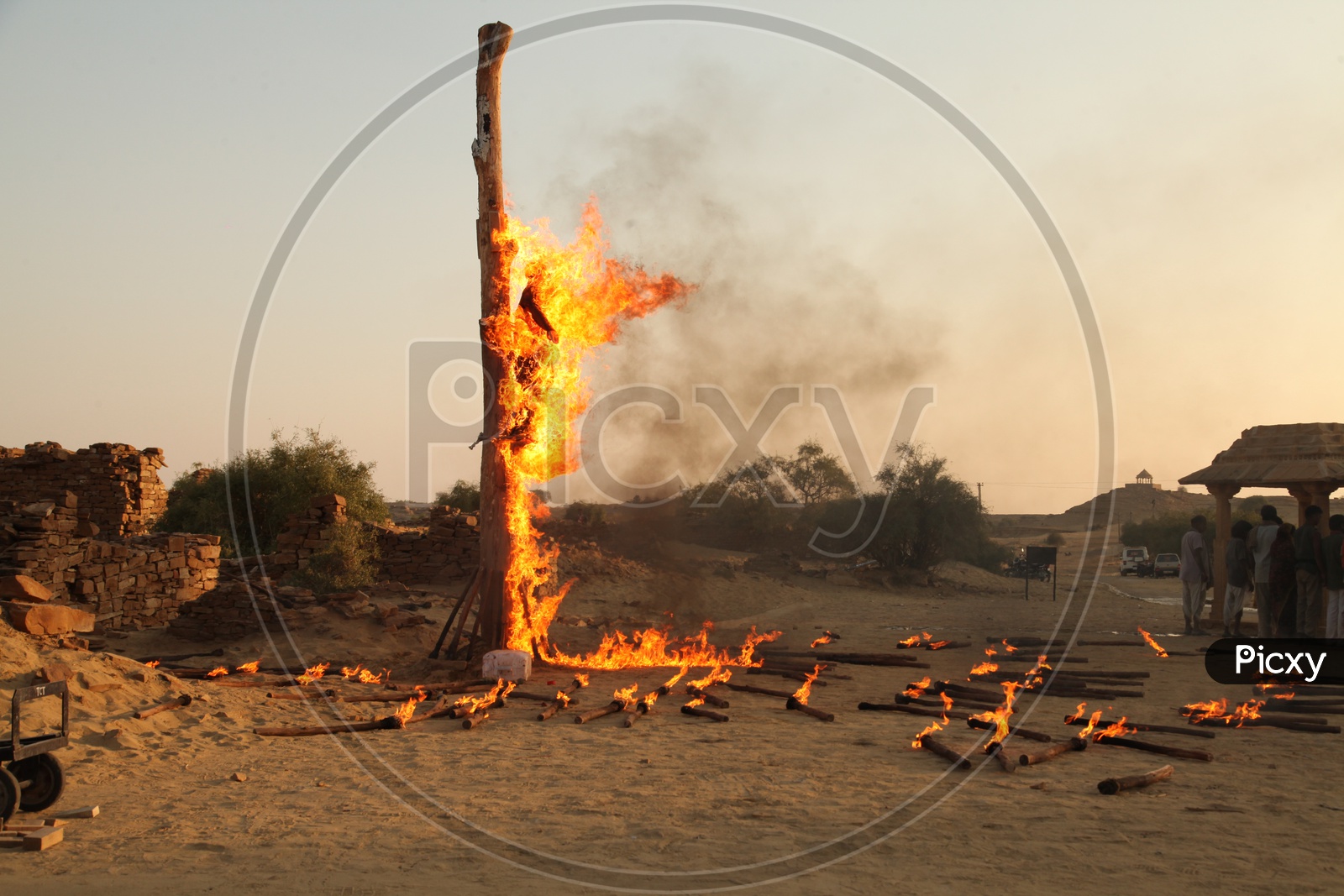 A man is tied to a pole and burnt