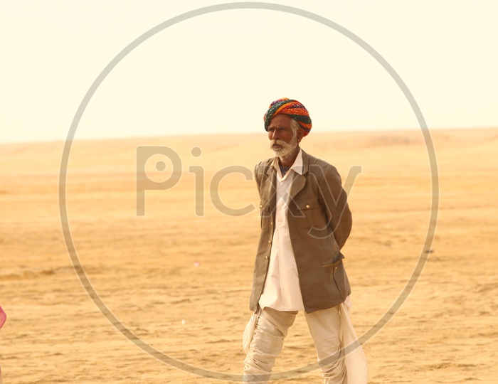 Rajasthani man walking in desert