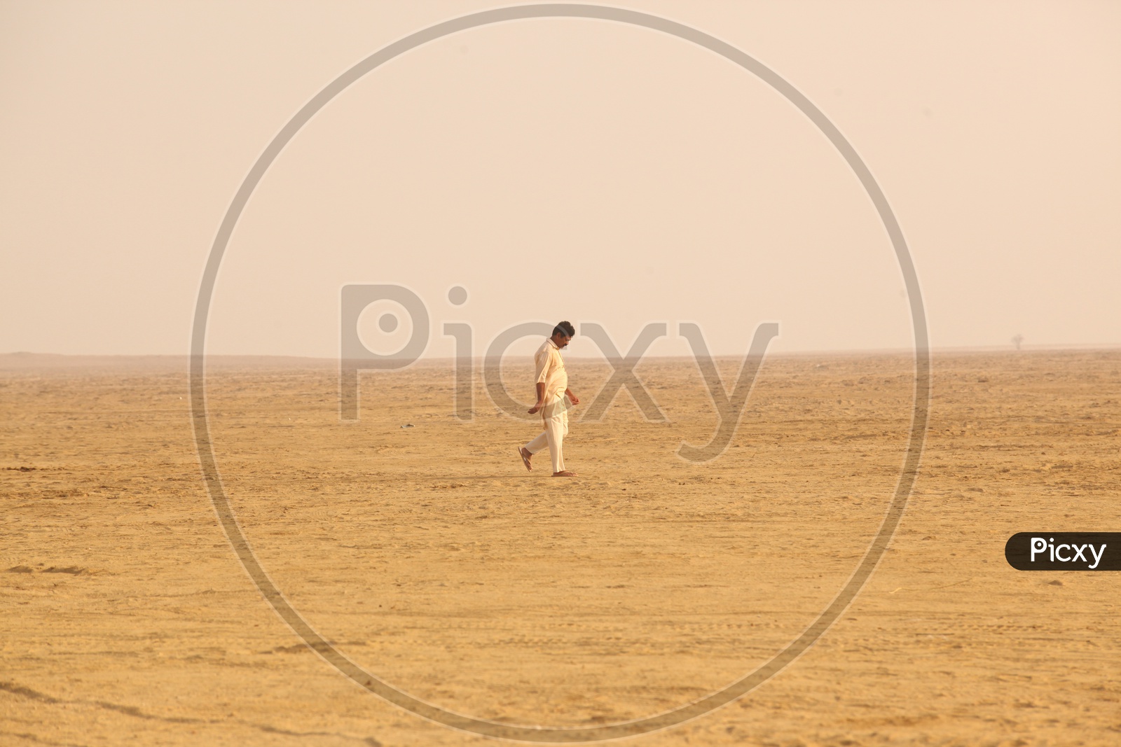 Indian man walking in Desert