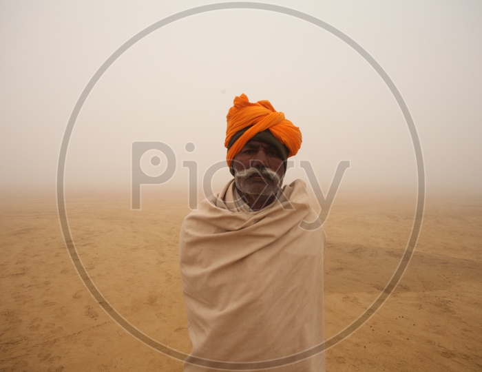 Old Rajasthani man in a desert