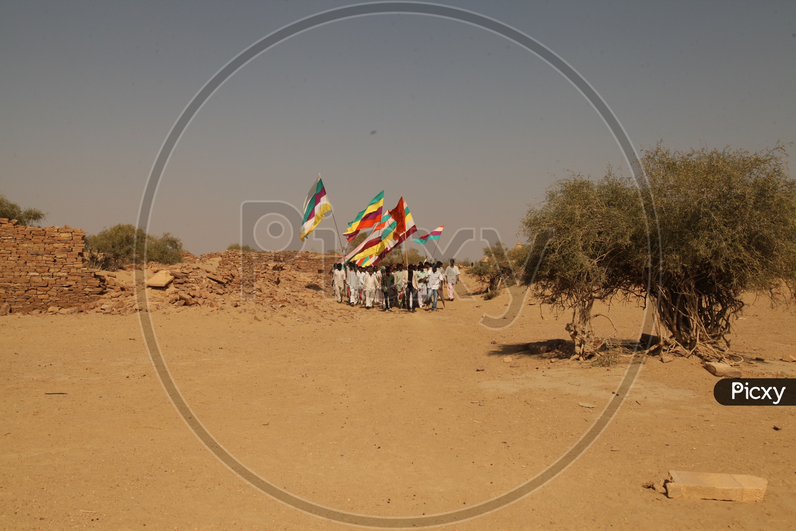 Agitation by men in the desert with flags