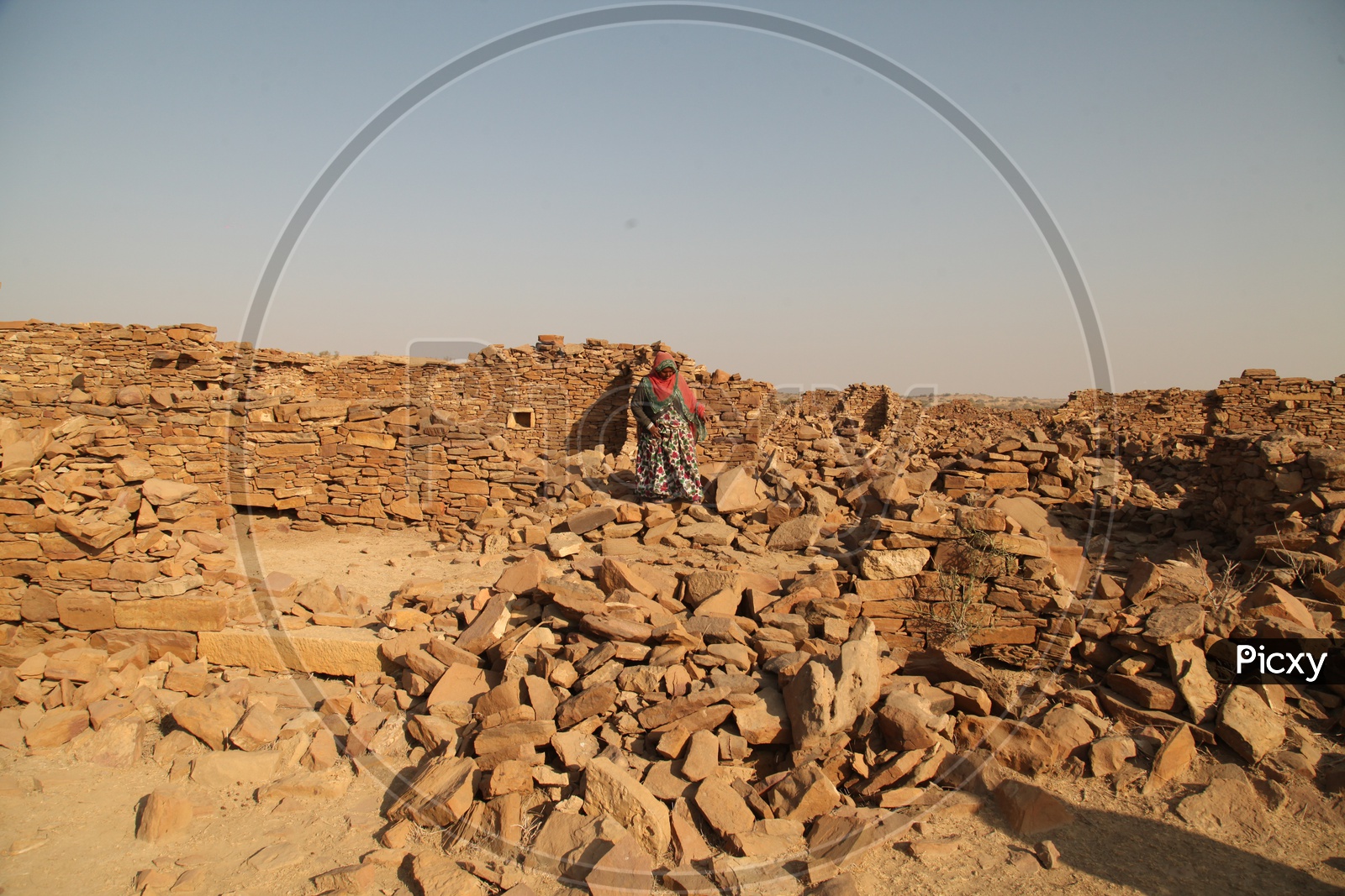 A women walking on the Ruins of the desert