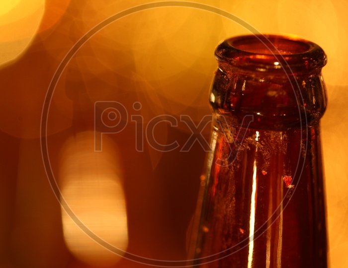 Close up of an empty glass bottle with bokeh background