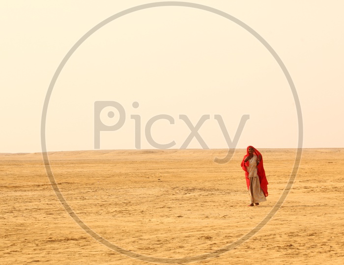 Indian Woman walking in desert