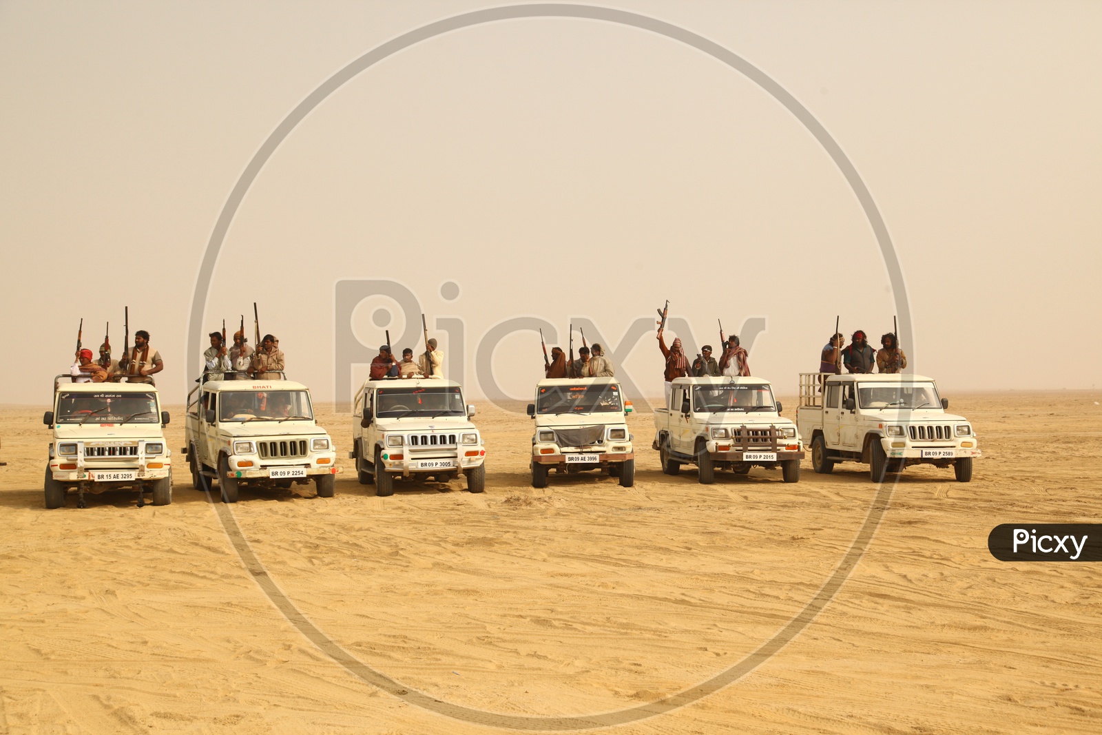 vehicles with people moving in desert