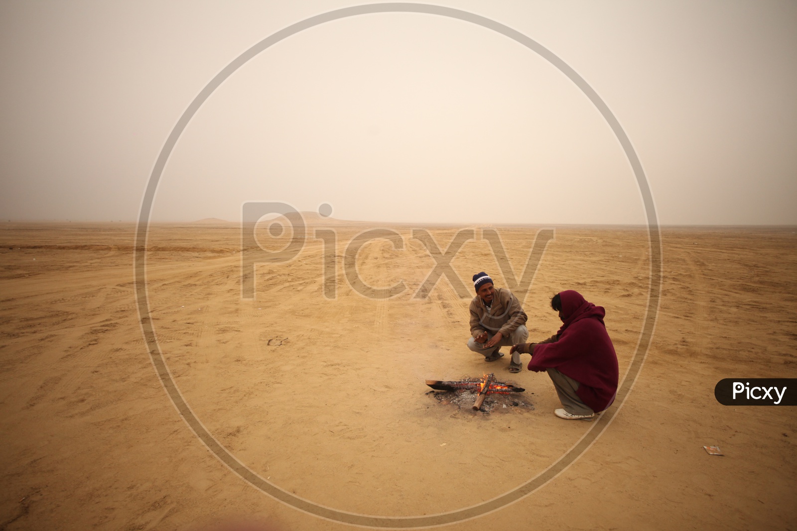 People in a desert with camp fire