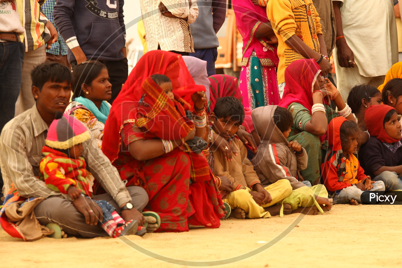 Rajasthani women and children sitting in the desert
