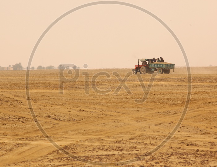A tractor moving in a desert