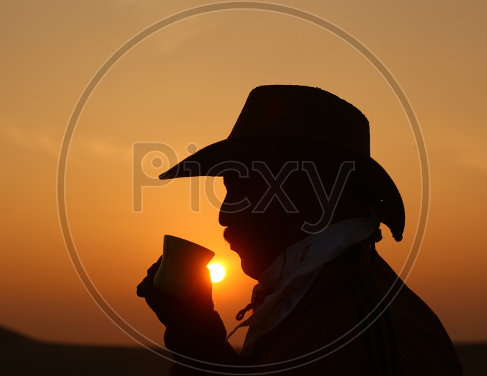 silhouette of a person with a cowboy hat