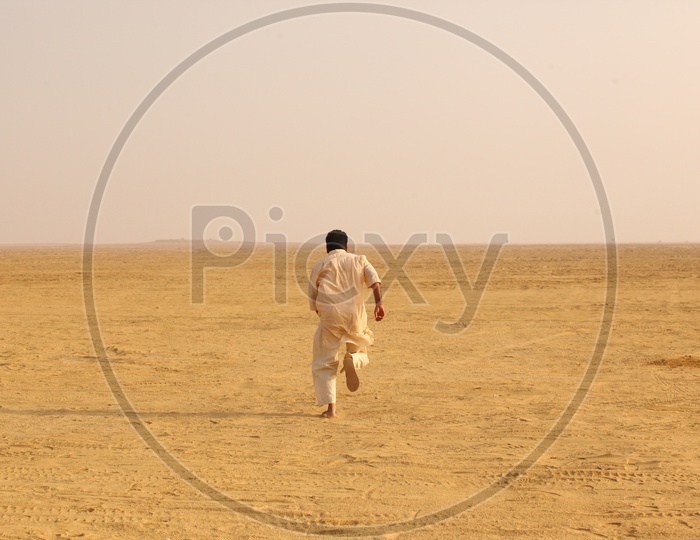 Indian Man running in desert