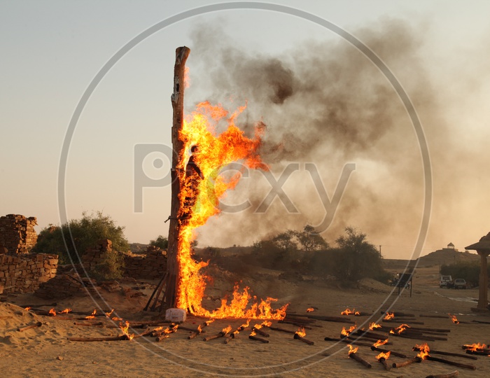 A man is burnt tied to a pillar in Agitation