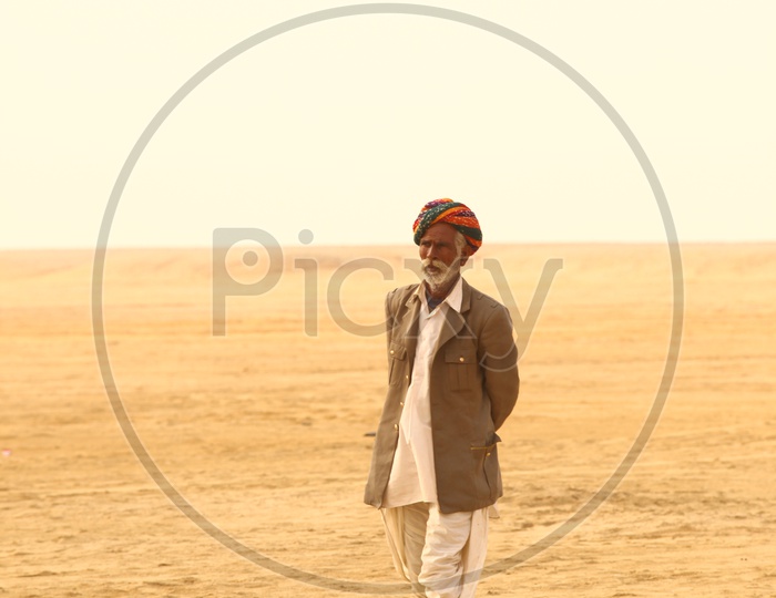 Rajasthani Man walking in desert