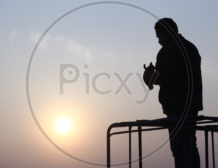 silhouette of a person and sunset in the background