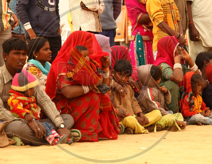Rajasthani women and children sitting in the desert