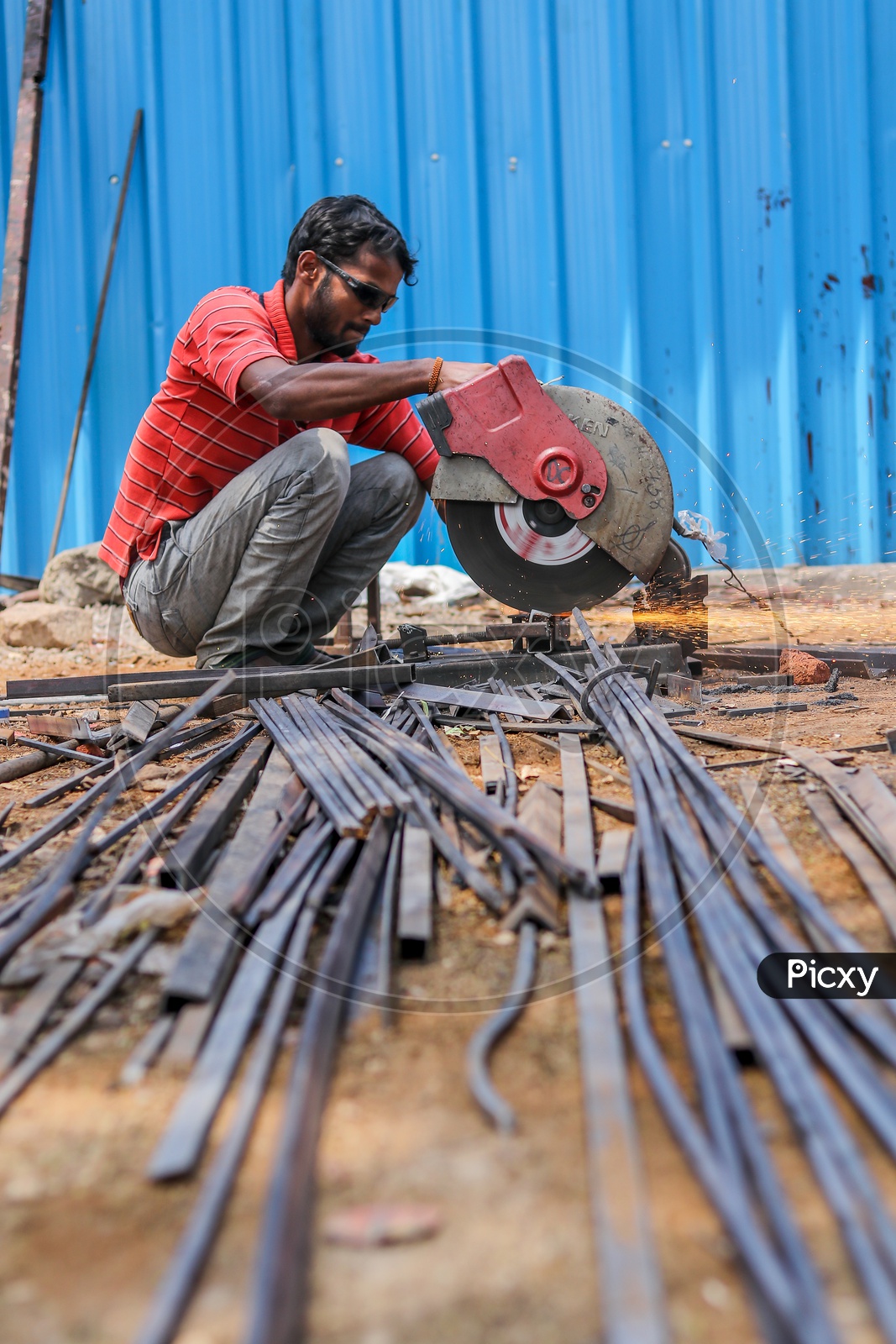Indian Cutter Worker cutting Iron Wedges with a Cutter