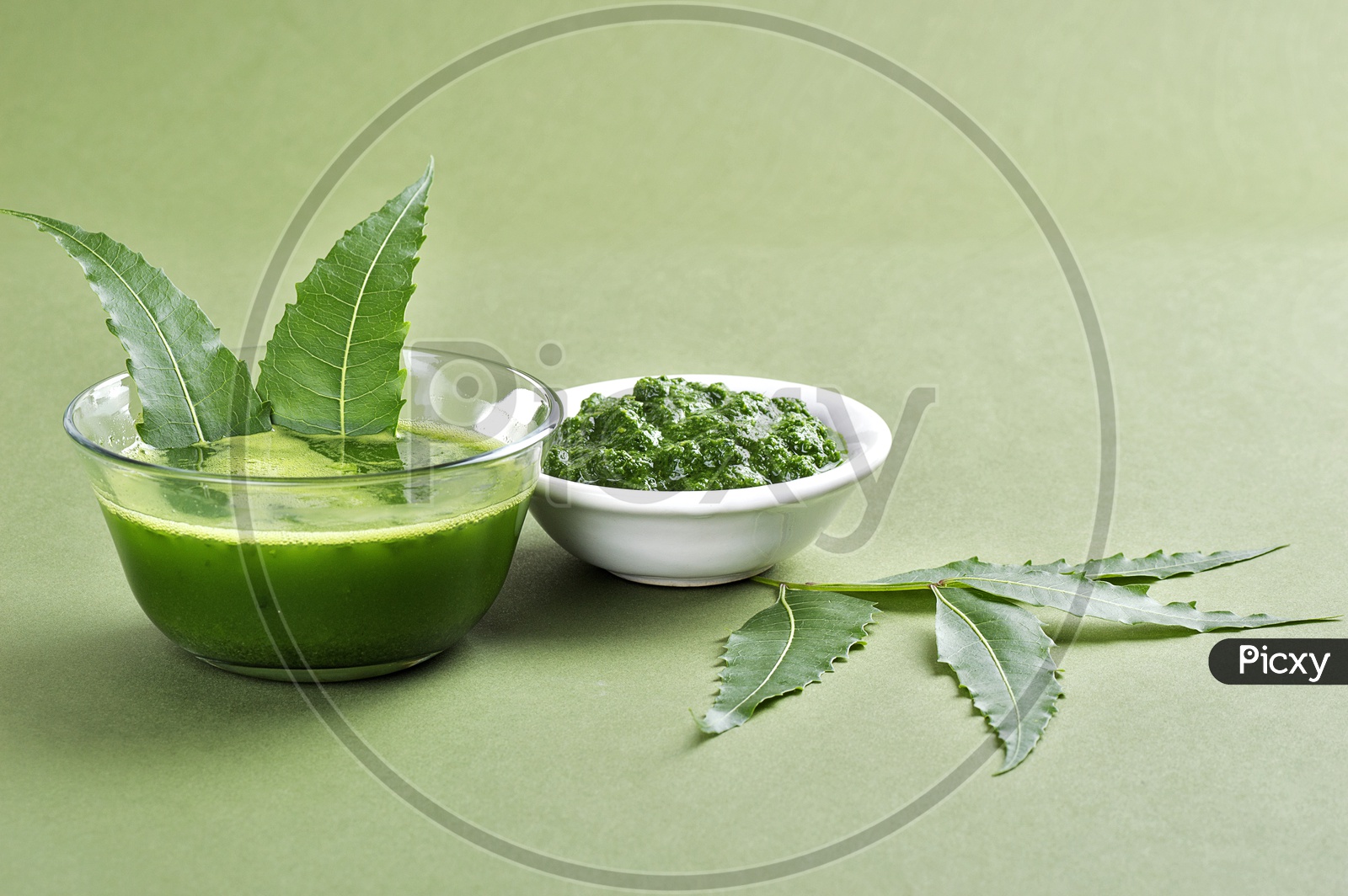 Medicinal Neem leaves paste and juice with leaves on green background