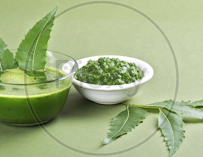 Medicinal Neem leaves paste and juice with leaves on green background