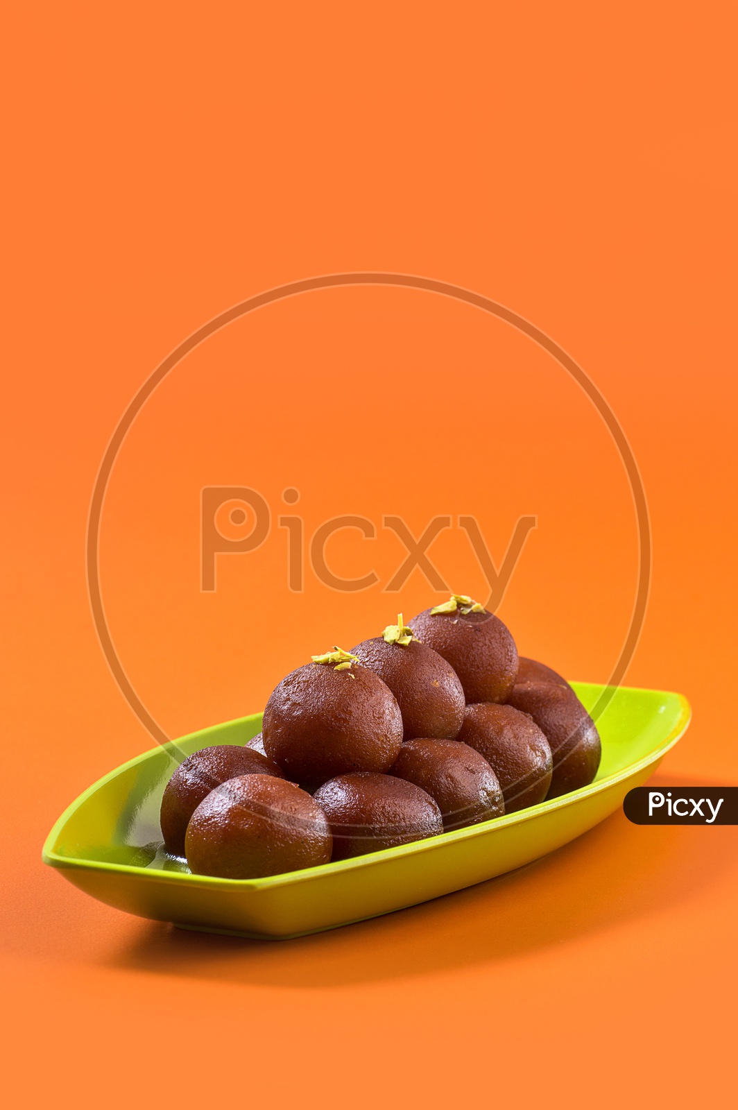 Image of Indian Dessert or Sweet Dish Gulab Jamun topped with Pistachio ...
