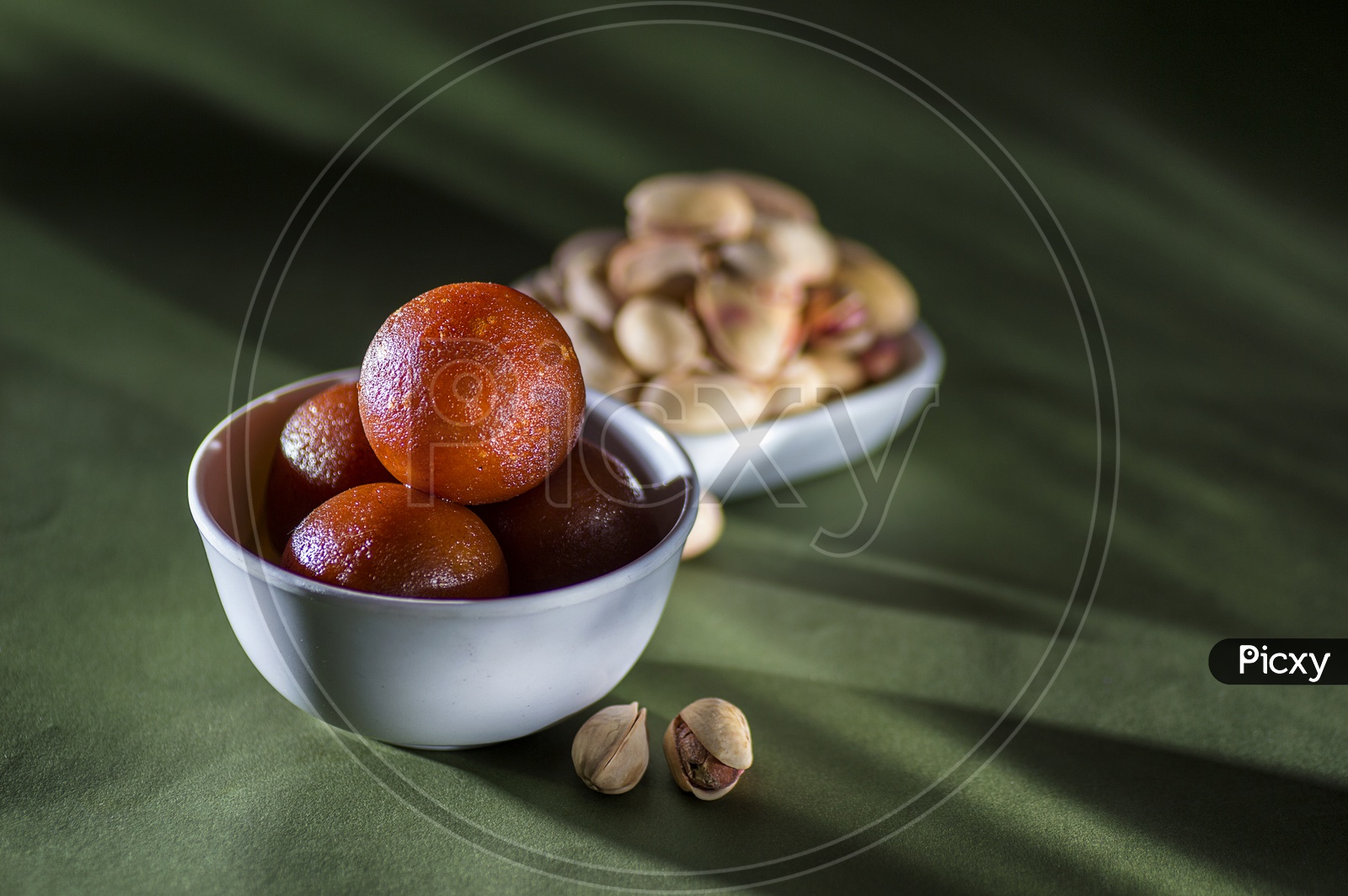 Indian Dessert or Sweet Dish Gulab Jamun in a Bowl with Almond and Pistachio