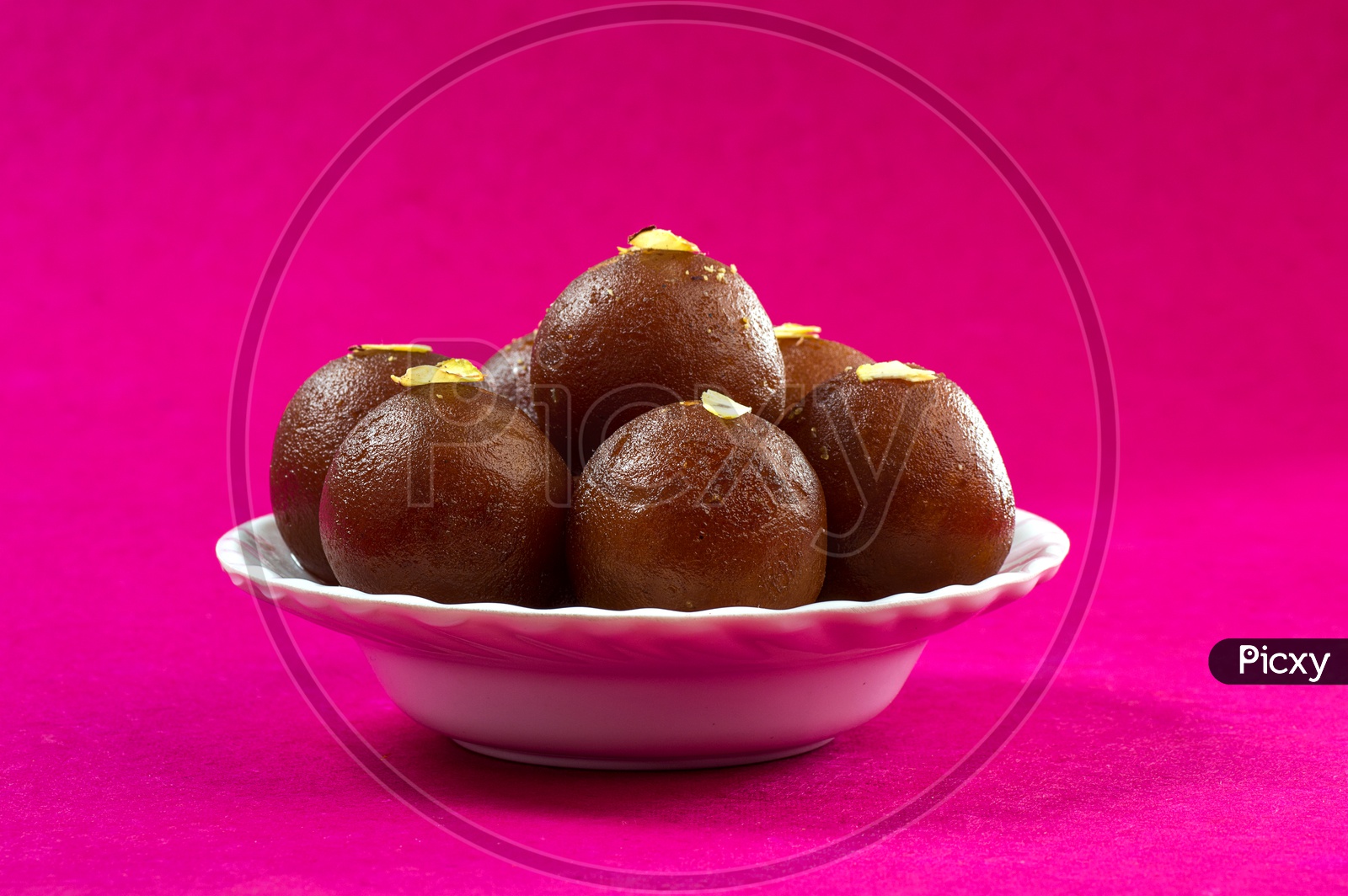 Image Of Indian Dessert Or Sweet Dish Gulab Jamun Topped With Pistachio image-of-indian-dessert-or-sweet-dish-gulab-jamun-topped-with-pistachio