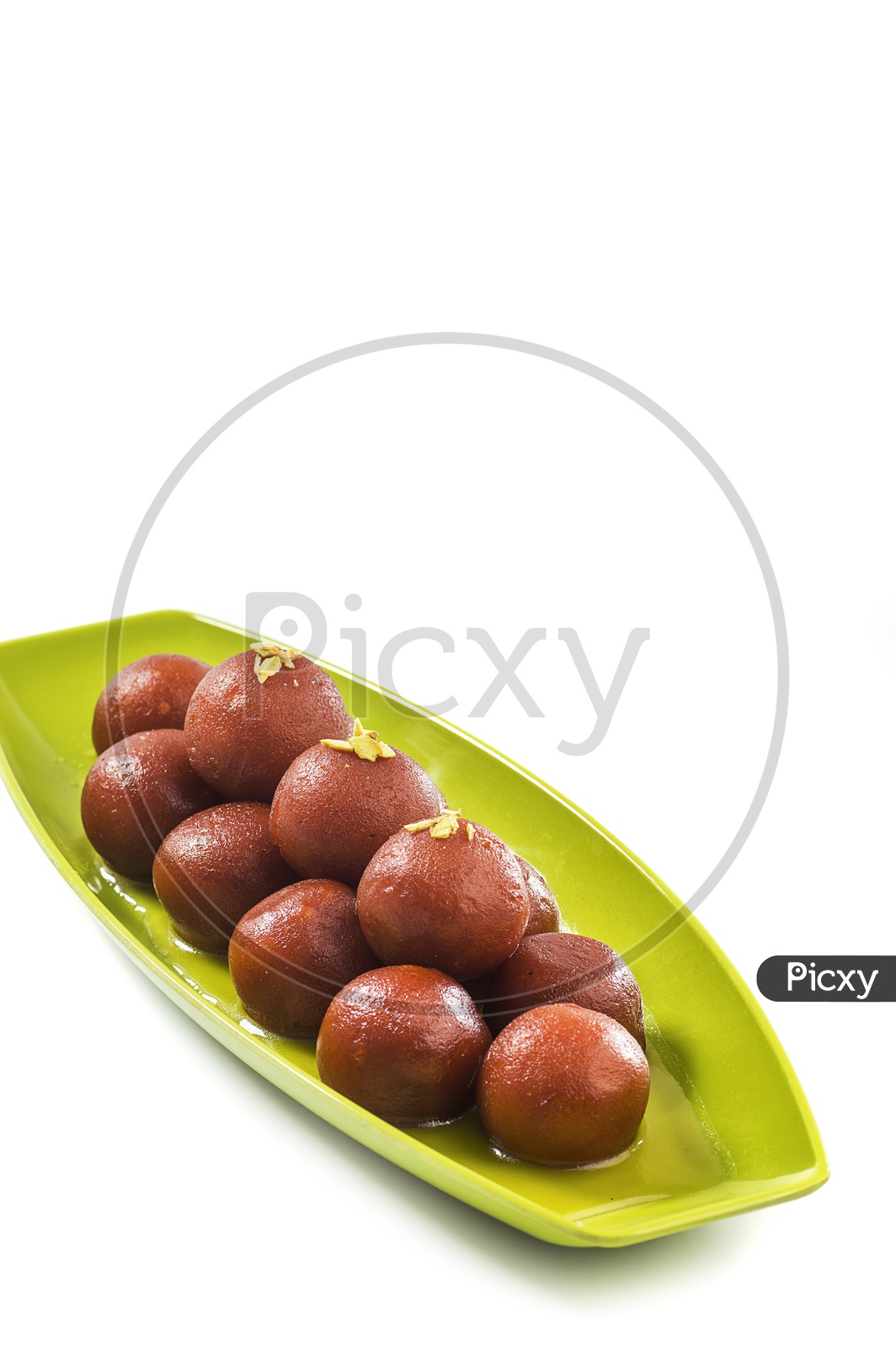 Indian Dessert or Sweet Dish Gulab Jamun topped with Pistachio in Plate